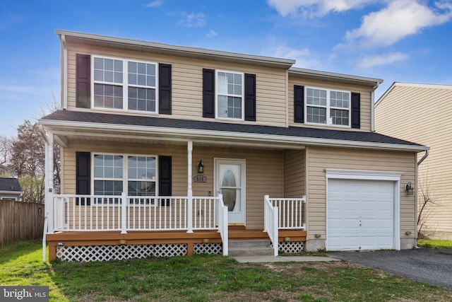 traditional home with a front lawn, driveway, a porch, and a garage
