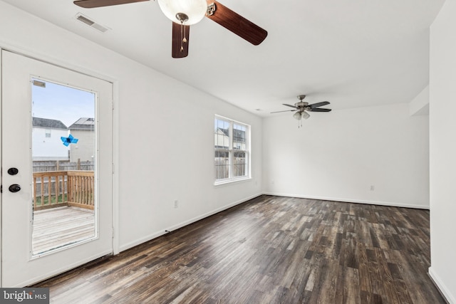 unfurnished room with ceiling fan, visible vents, and wood finished floors
