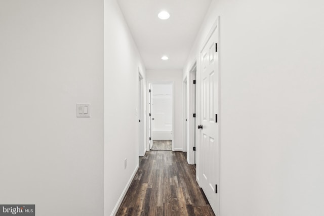 hallway with baseboards, dark wood-style floors, and recessed lighting