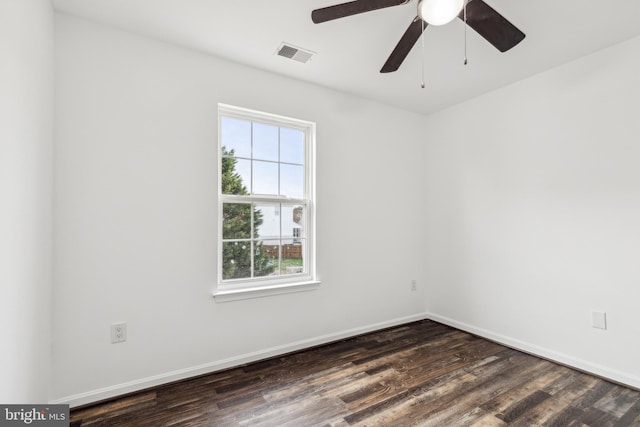 empty room featuring baseboards, visible vents, a ceiling fan, and wood finished floors