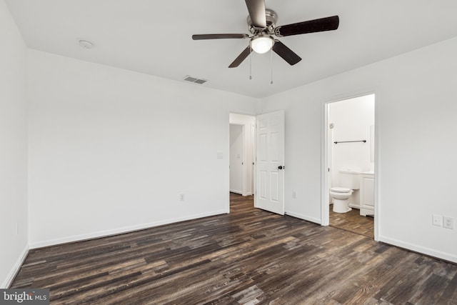 unfurnished bedroom with wood finished floors, ensuite bath, baseboards, visible vents, and ceiling fan