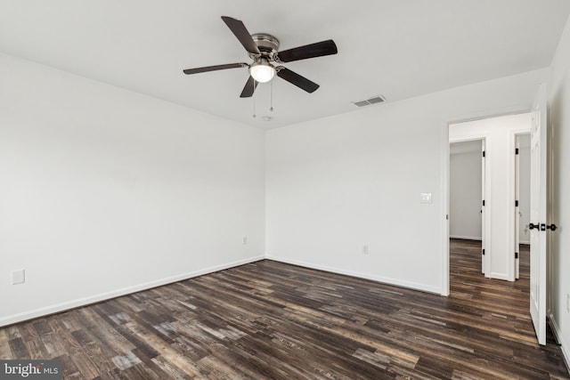unfurnished room featuring a ceiling fan, dark wood-style floors, baseboards, and visible vents
