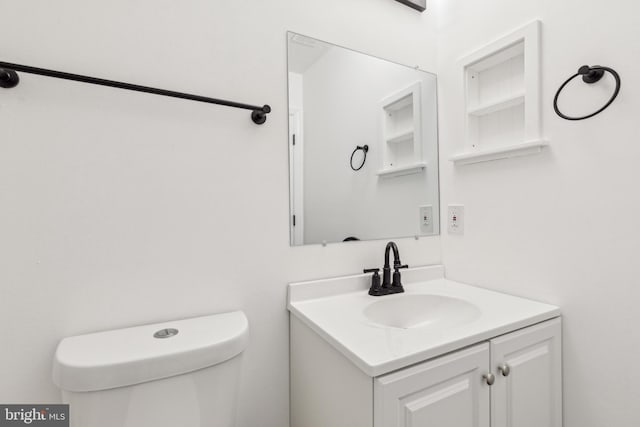bathroom with toilet and vanity