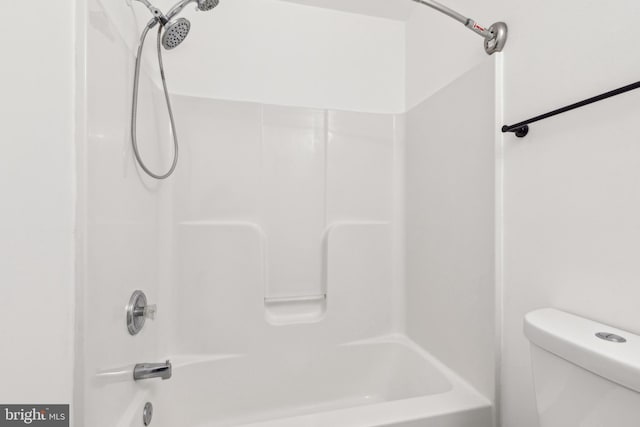 bathroom featuring shower / bathing tub combination and toilet