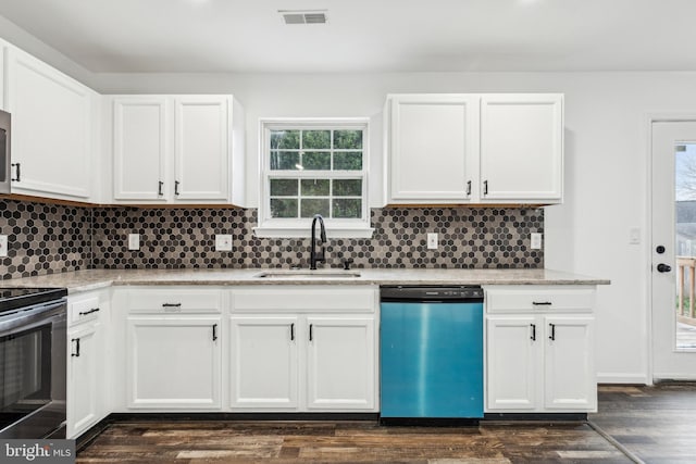 kitchen with a sink, a wealth of natural light, dishwasher, visible vents, and range with electric cooktop