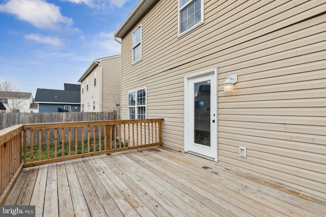 wooden terrace featuring fence