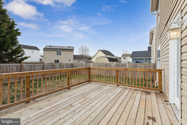 deck with a fenced backyard and a residential view