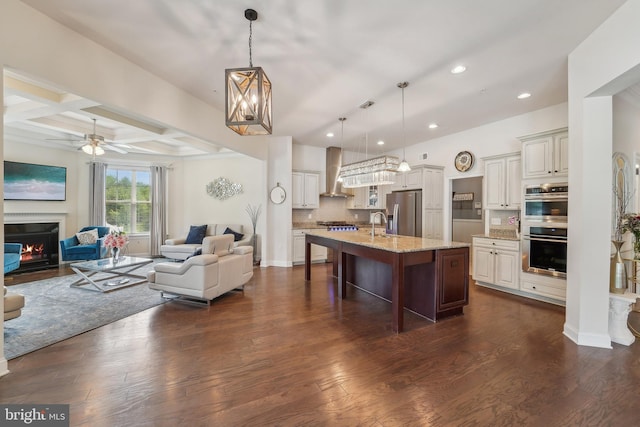 2042 Drovers Ln, Cooksville, MD 21723 - kitchen featuring stainless steel appliances, open floor plan, wall chimney range hood, a kitchen breakfast bar, and recessed lighting