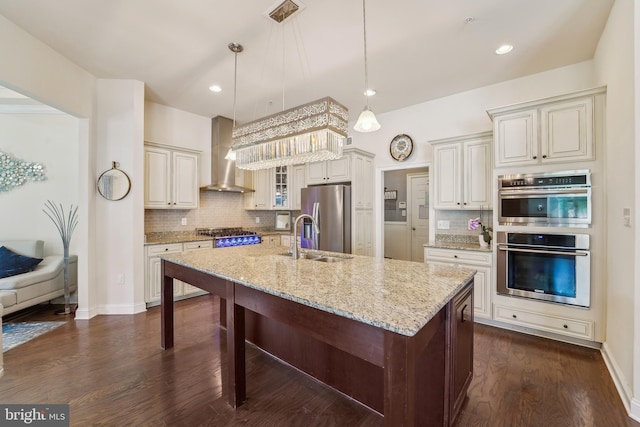 2042 Drovers Ln, Cooksville, MD 21723 - kitchen featuring appliances with stainless steel finishes, a sink, backsplash, light stone countertops, and wall chimney range hood