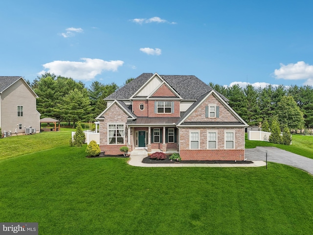 2042 Drovers Ln, Cooksville, MD 21723 - craftsman-style home featuring covered porch, a front lawn, brick siding, driveway, and cooling unit