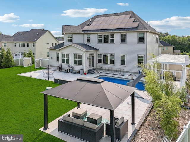 2042 Drovers Ln, Cooksville, MD 21723 - back of house featuring a patio area, roof mounted solar panels, outdoor lounge area, entry steps, and roof with shingles