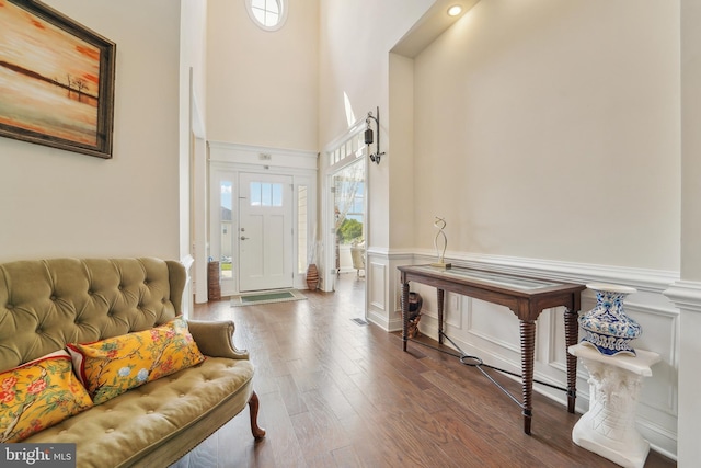 2042 Drovers Ln, Cooksville, MD 21723 - foyer entrance featuring wood finished floors, wainscoting, a towering ceiling, and a decorative wall