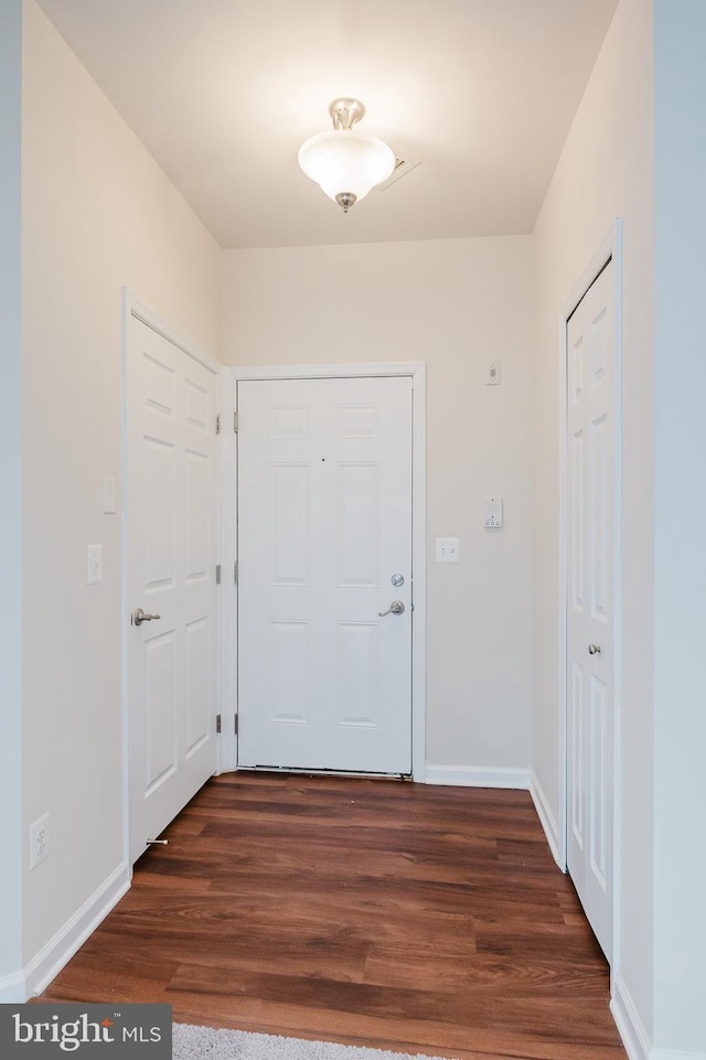 5207 Wyndholme Cir Unit 402, Baltimore, MD 21229 - doorway to outside featuring baseboards and dark wood finished floors