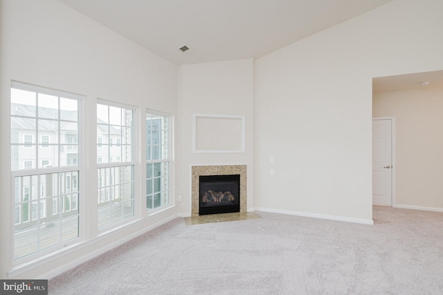 5207 Wyndholme Cir Unit 402, Baltimore, MD 21229 - unfurnished living room with baseboards, carpet flooring, visible vents, and a fireplace with flush hearth