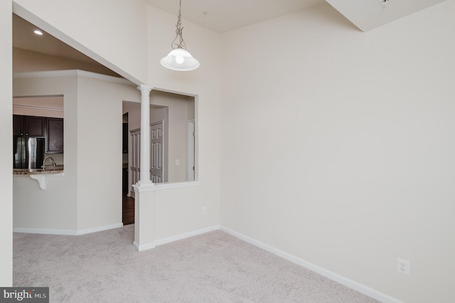 5207 Wyndholme Cir Unit 402, Baltimore, MD 21229 - spare room featuring a sink, ornate columns, recessed lighting, carpet flooring, and baseboards