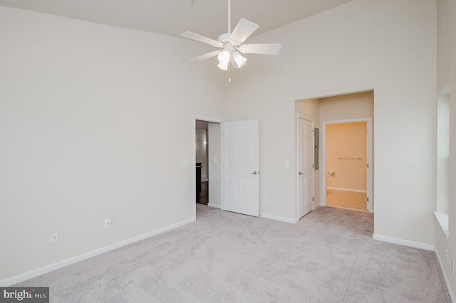 5207 Wyndholme Cir Unit 402, Baltimore, MD 21229 - unfurnished bedroom featuring ensuite bath, a towering ceiling, carpet floors, and baseboards