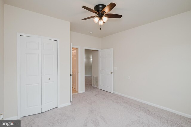 5207 Wyndholme Cir Unit 402, Baltimore, MD 21229 - unfurnished bedroom featuring baseboards, a closet, a ceiling fan, and carpet