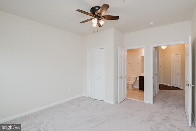 5207 Wyndholme Cir Unit 402, Baltimore, MD 21229 - unfurnished bedroom with a closet, light colored carpet, ceiling fan, connected bathroom, and baseboards