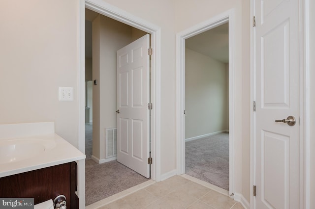 5207 Wyndholme Cir Unit 402, Baltimore, MD 21229 - bathroom with vanity, baseboards, visible vents, and tile patterned flooring