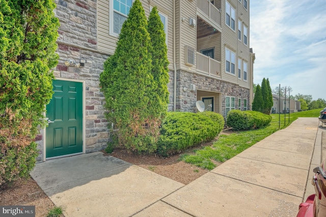 5207 Wyndholme Cir Unit 402, Baltimore, MD 21229 - doorway to property with a balcony and stone siding