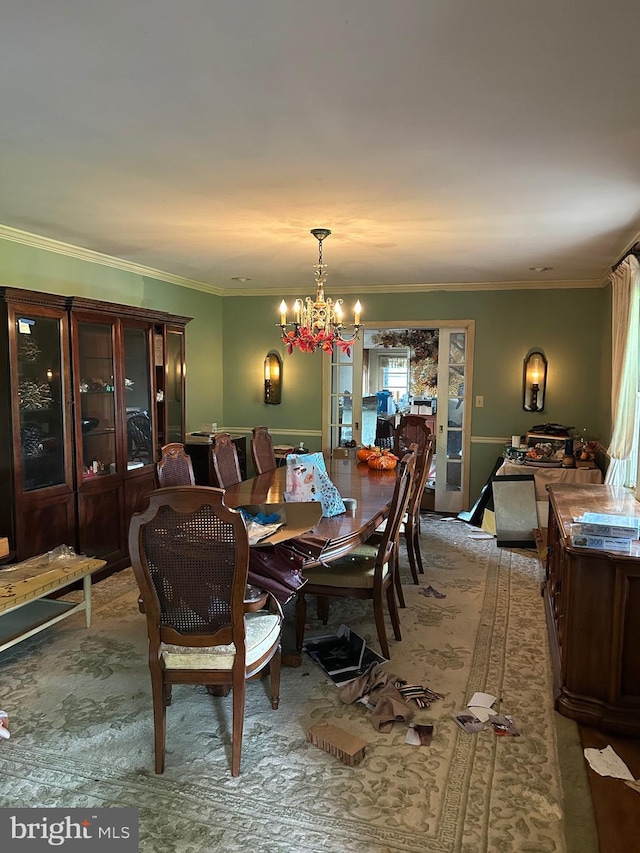 dining space featuring a chandelier and ornamental molding