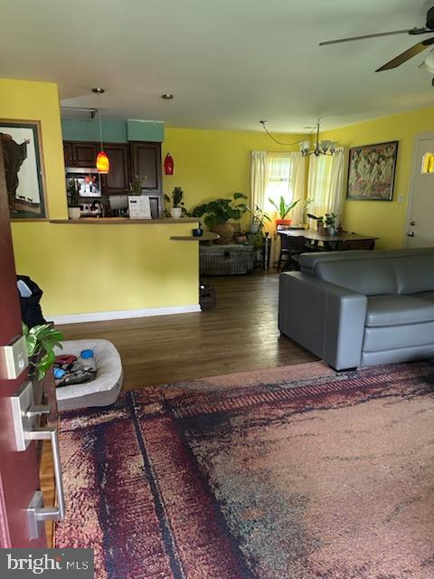 9011 Spring Acres Rd, Clinton, MD 20735 - living area with ceiling fan, wood finished floors, and a chandelier