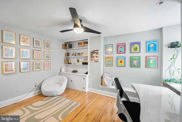 home office with light wood-style flooring, baseboards, and ceiling fan
