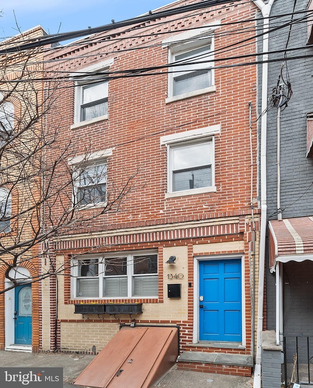 view of front of house featuring brick siding