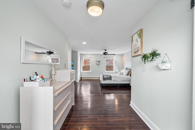 bedroom with baseboards, dark wood-style flooring, recessed lighting, and baseboard heating