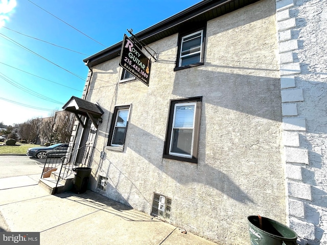 view of side of home featuring stucco siding