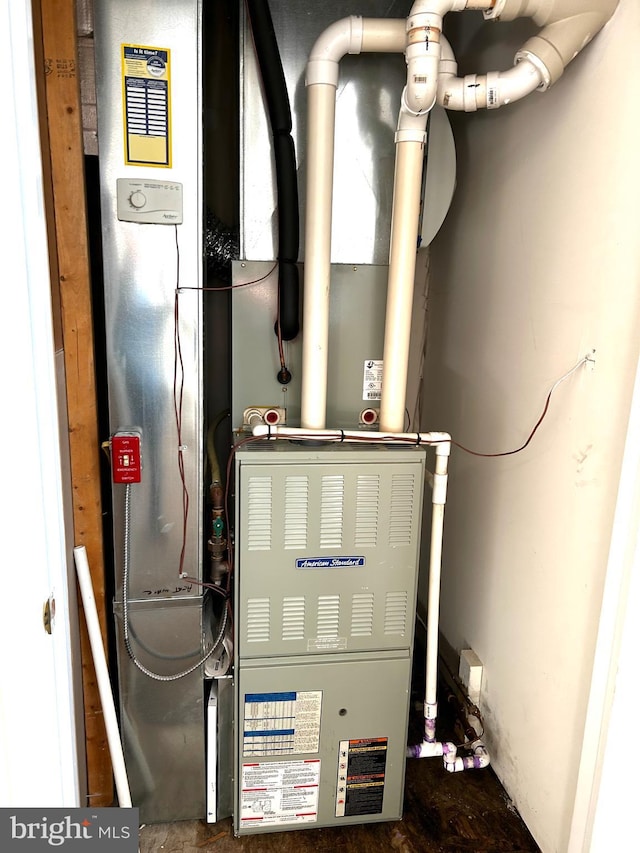 utility room featuring heating unit