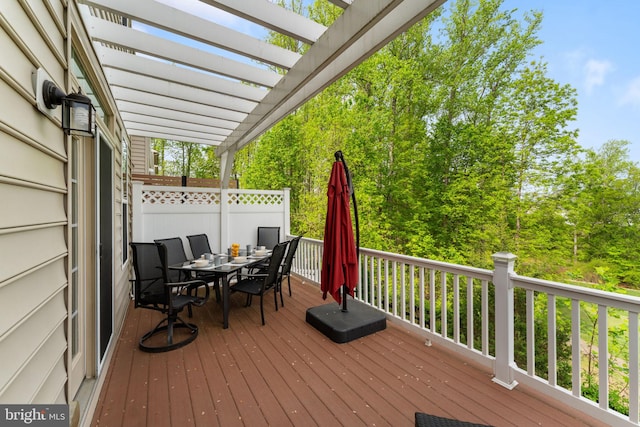 deck featuring a pergola and outdoor dining area