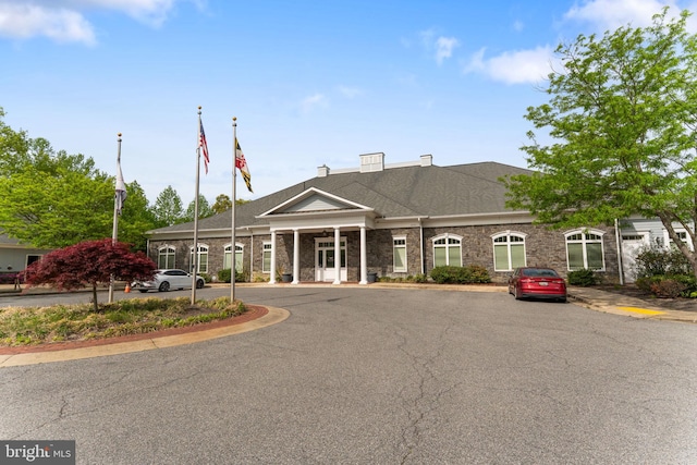 view of property featuring uncovered parking