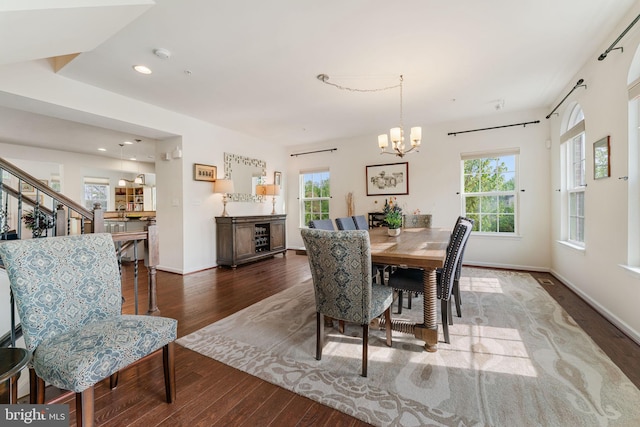 dining room featuring recessed lighting, an inviting chandelier, wood finished floors, and baseboards