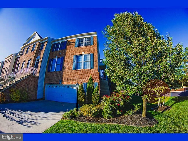 view of front of house with an attached garage, driveway, stairway, and brick siding