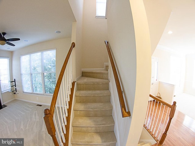 stairs featuring baseboards, recessed lighting, a ceiling fan, and a wealth of natural light