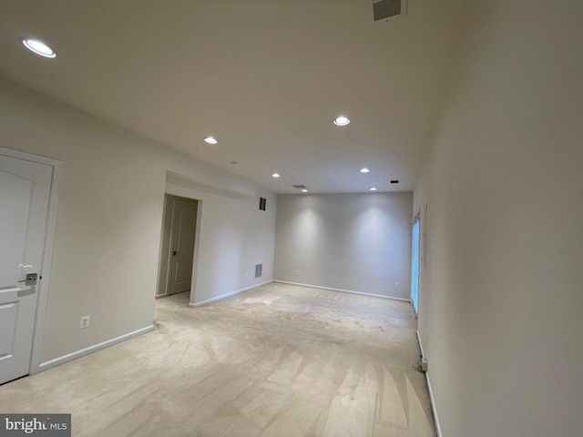 unfurnished room featuring recessed lighting, baseboards, visible vents, and light carpet