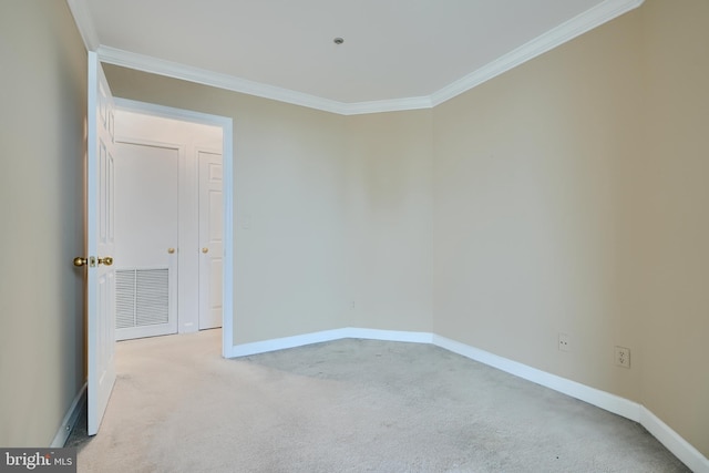 carpeted spare room with crown molding and baseboards