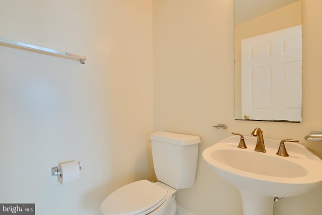 bathroom featuring toilet and a sink