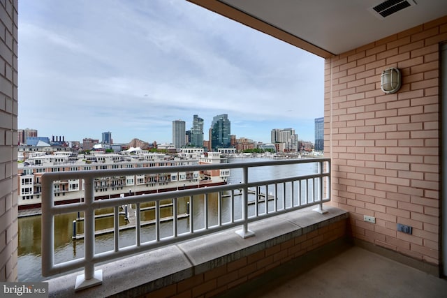 balcony featuring a view of skyline and a water view