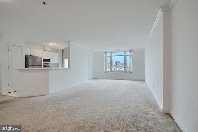 unfurnished living room featuring light colored carpet, ornamental molding, and baseboards