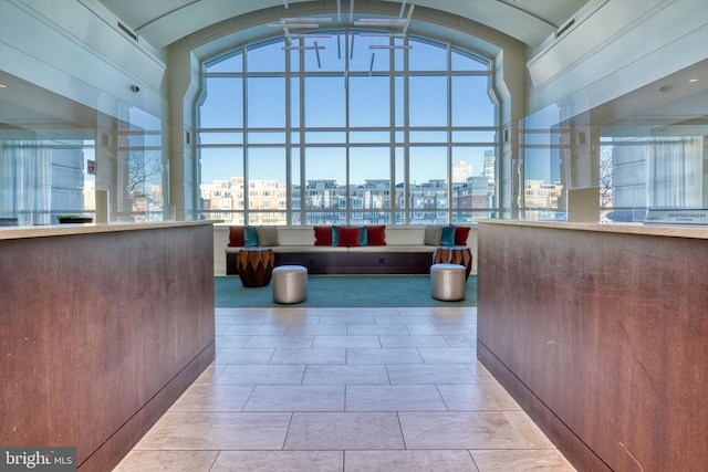welcome area featuring a city view and lofted ceiling