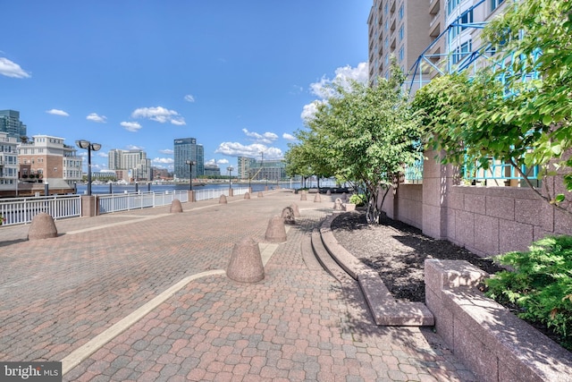 surrounding community featuring a city view and fence