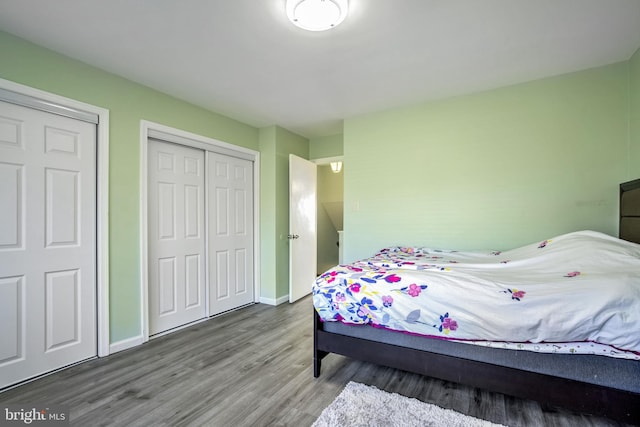 bedroom with wood finished floors and baseboards
