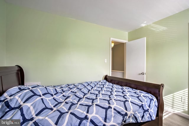 bedroom with wood finished floors