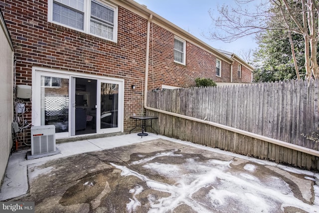 view of patio with cooling unit and fence
