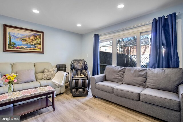 living room with light wood finished floors and recessed lighting