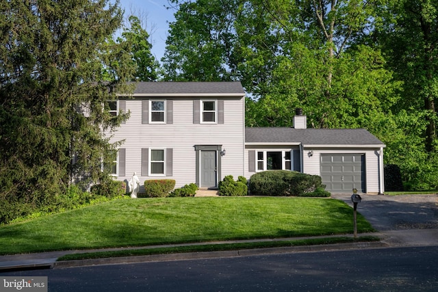 9801 Pulham Rd, Burke, VA 22015 - colonial-style house with a garage, a front lawn, aphalt driveway, and a chimney