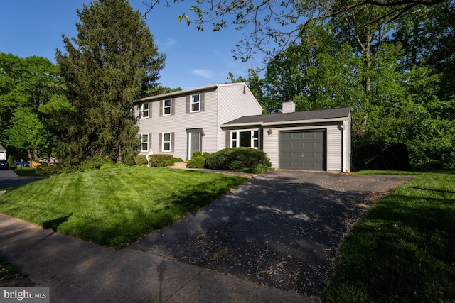 9801 Pulham Rd, Burke, VA 22015 - colonial inspired home featuring a garage, a front yard, driveway, and a chimney