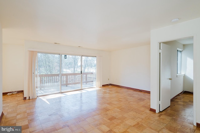 spare room featuring baseboards
